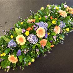Casket spray in spring brights