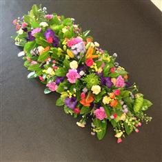 Casket spray in summer brights