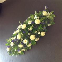 Casket spray in blues and whites