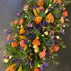 Casket spray in orange and purple