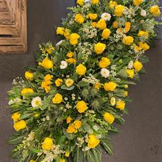 Casket spray in yellows and whites