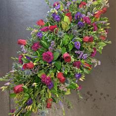 Casket spray in red and purple