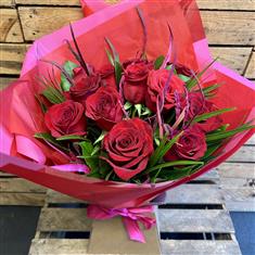 12 red roses in a vase